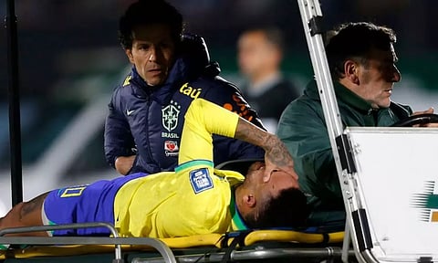 Brazil's Neymar is brought off the pitch after sustaining an injury (Image: REUTERS)