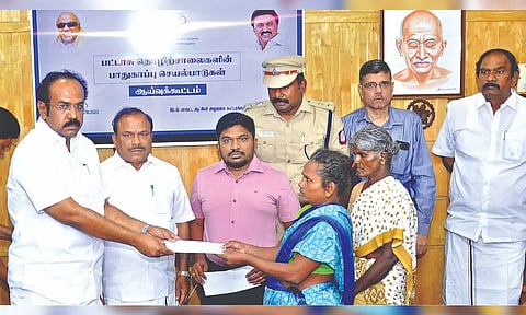 Ministers Thangam Thennarasu and CV Ganesan handing over relief to a victim’s kin on Wednesday.