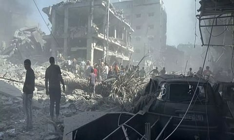 Palestinians in Gaza clear away rubble from an Israeli air strike (Image: ANI)