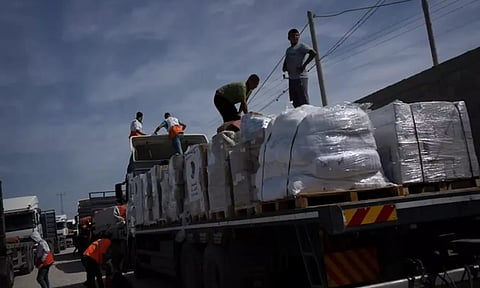 Trucks with humanitarian aid for the Gaza Strip enter from Egypt in Rafah. (AP)