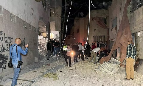 People inspect the damage after an Israeli strike hit a compound beneath a mosque (Photo: Reuters)