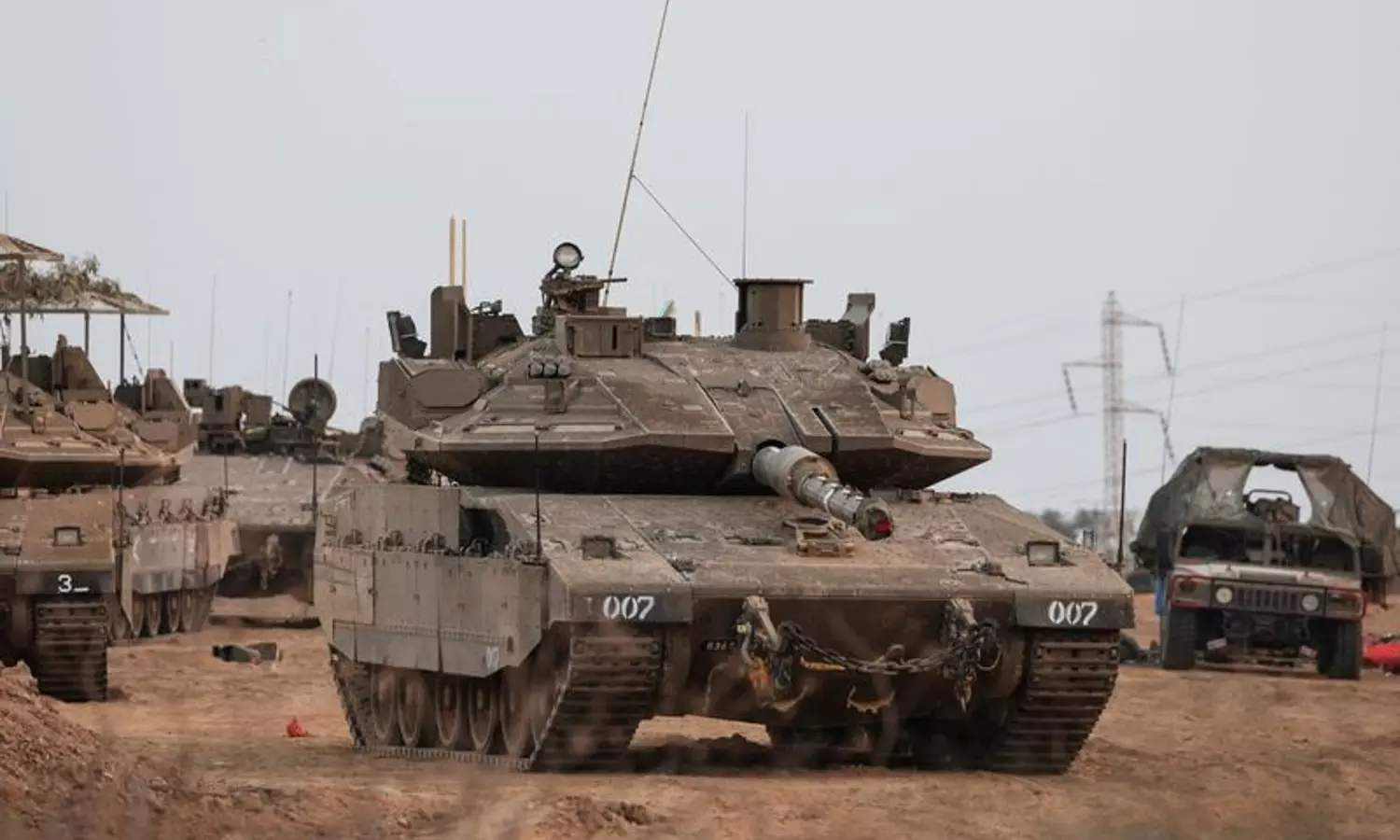 An Israeli tank and military vehicles are seen near Israel's border with the Gaza Strip, in southern Israel (Photo: Reuters)