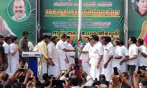 Edappadi K Palaniswami hoisting AIADMK’s flag at a meeting in Tirupur on Friday