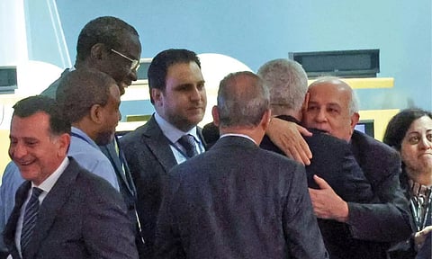 Riyad H Mansour, Permanent Observer of Palestine is greeted by fellow diplomats after the adoption of a draft UN resolution