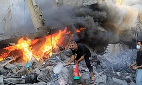 A person trying to douse the fire.