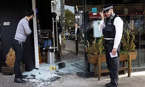 A vandalised Kosher restaurant near a bridge with 'Free Palestine' painted on it, in Golders Green, London (Photo: Reuters)