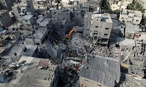 Palestinians search for casualties, at the site of Israeli strikes on houses, at the Magazi Refugee Camp (Reuters)
