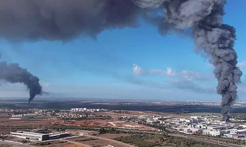 Smoke is seen in the Rehovot area as rockets are launched from the Gaza Strip, in Israel. (Reuters)
