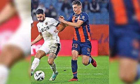 Montpellier’s Joris Chotard fights for the ball with Morgan Sanson in their match