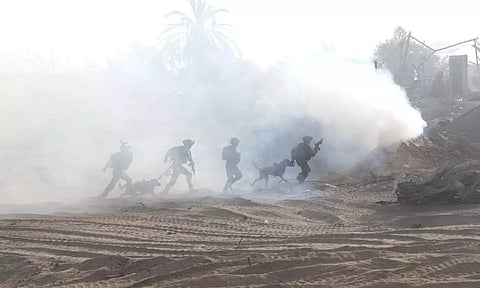 Israeli soldiers take a position inside the Gaza Strip