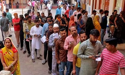 People wait in queues to cast their votes at a polling station during the Madhya Pradesh State assembly election in Indore (Reuters)
