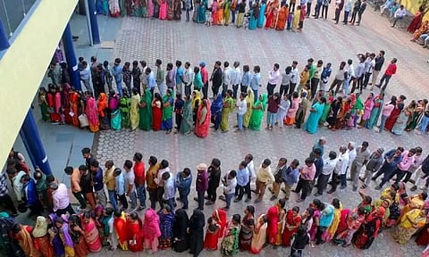 People wait in queue to cast their votes for the Madhya Pradesh Assembly election in Bhopal. (PTI)