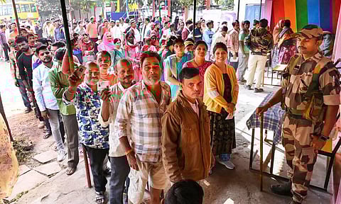 People wait in queues to cast their votes at a polling station during the Madhya Pradesh state assembly election in Indore. (PTI)
