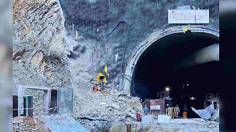 A Hindu priest prays at a makeshift shrine outside the entrance of a tunnel where workers are trapped after a portion of the tunnel collapsed in Uttarkashi in the northern state of Uttarakhand (Photo/PTI)