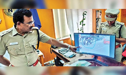 The Nilgiris Superintendent of Police Sundaravadivel showing the CCTV footage to prove that the girl was not handcuffed