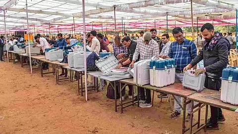 Polling officials collect EVMs and other election material at a distribution centre ahead of voting for Rajasthan Assembly elections (Photo/PTI)