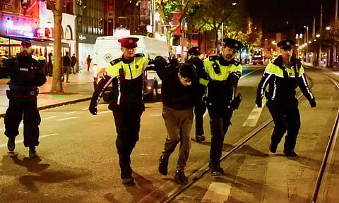 Members of the Garda Public Order Unit detain a man (Photo: Reuters)