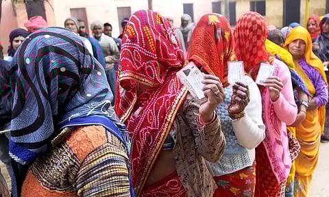 Women wait in queue to cast their vote at a polling booth in Rajasthan. (PTI)