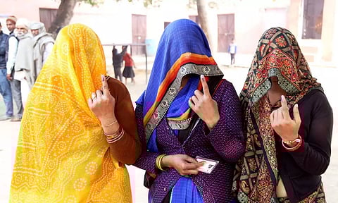 Women show inked finger after casting their votes at a polling booth in Rajasthan. (PTI)