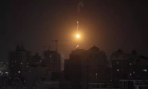  An explosion of a drone is seen in the sky over the city during a Russian drone strike, amid Russia's attack on Ukraine, in Kyiv (Reuters)