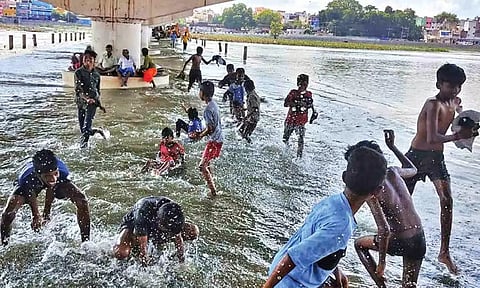 Boys having fun in the flooded Vaigai under the Albert Victor bridge in Madurai on Saturday (Photo: Imthiyas Ali)