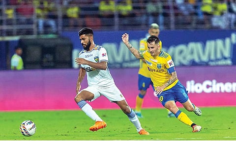 Ankit Mukherjee and Adrian Luna challenge for the ball during the match