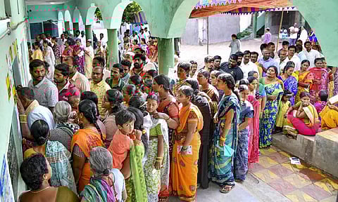 People wait in queue tp cast their votes at a polling booth in Hyderabad. (PTI)