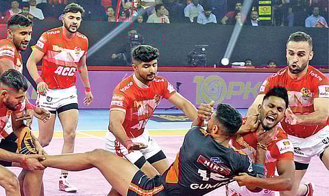 Gujarat Giants players tackle a U Mumba player