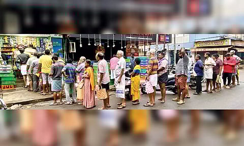 Residents queueing up in front of shops to buy milk after the cyclone and torrential rains disrupted supply in the city and surrounding areas since on Monday