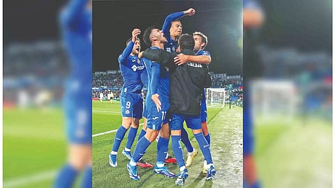 Getafe players celebrate their late winner against Valencia