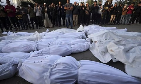 Palestinians mourn their relatives killed in the Israeli bombardment of the Gaza Strip (AP)