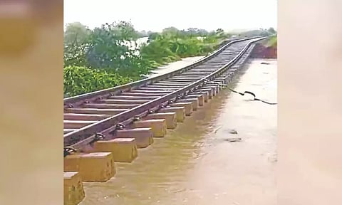 The heavily eroded railway track hanging dangerously near Srivaikuntam station on Monday.