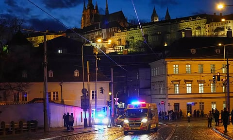 An ambulance drives towards the building of Philosophical Faculty of Charles University in downtown Prague, Czech Republic, Thursday, Dec. 21, 2023. (AP)
