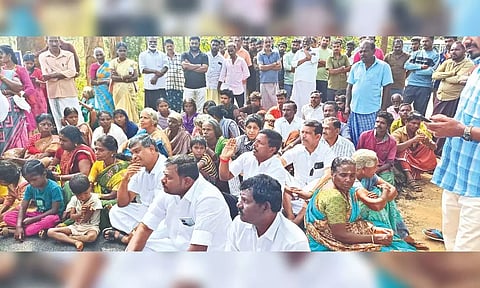 Villagers block road in protest.