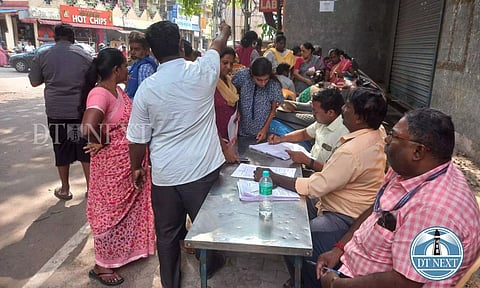 People filling out application forms to avail the relief amount in a PDS at Chetpet. Akshay Kumar