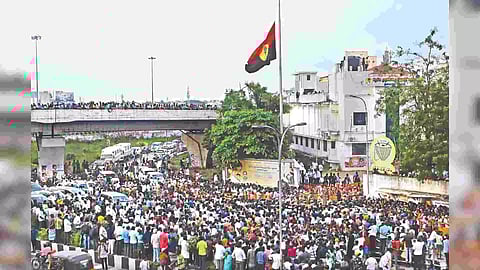 DMDK flag flies half mast as crowds swarmed party headquarters in Koyambedu on hearing the demise of Vijayakant (Photo: Hemanthan M)