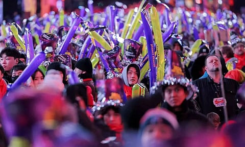 Revellers hold balloons during the New Year's Eve celebrations at Times Square (Reuters)