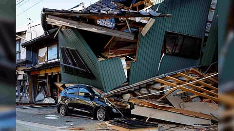 A damaged car stands near a collapsed house, following an earthquake, in Nanao, Ishikawa prefecture (Photo/Reuters)