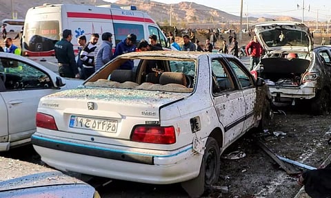People gather at the scene of explosions during a ceremony held to mark the death of late Iranian General Qassem Soleimani
