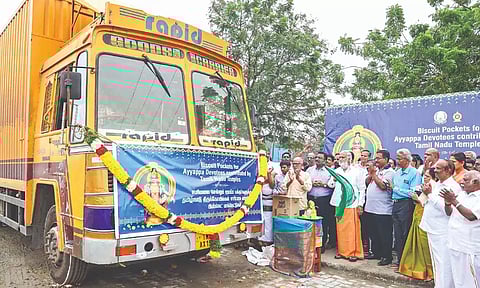 Minister Sekarbabu flags off a container lorry loaded with biscuit packets in Vanagaram on Friday