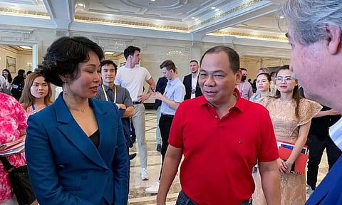 VinFast CEO Le Thi Thu Thuy speaks to VinGroup founder and Chairman Pham Nhat Vuong at a VinFast event in Nha Trang (Reuters)
