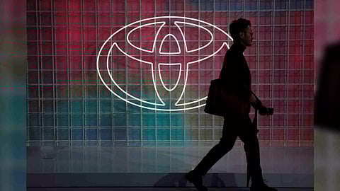 A man walks past a Toyota logo at the Tokyo Motor Show, in Tokyo (Photo/Reuters)