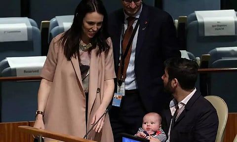 New Zealand Prime Minister Jacinda Ardern walks back to her baby Neve and partner Clarke Gayford (Reuters)