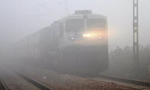 A train runs amid low visibility due to dense fog. (PTI)