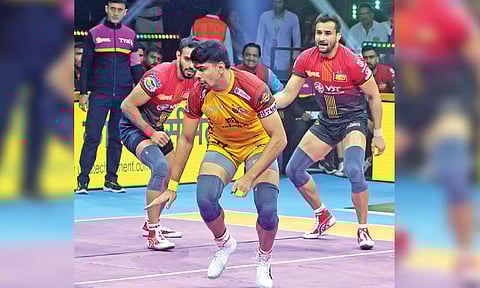 Telugu Titans’ Pawan Sehrawat goes for a raid against Bengaluru Bulls