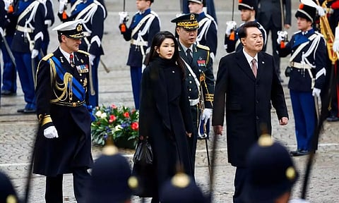 South Korea's President Yoon Suk Yeol and his wife Kim Keon Hee walk during a ceremony in Amsterdam, Netherlands 
