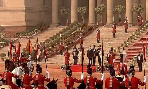 President Droupadi Murmu with French President Emmanuel Macron in a traditional buggy. (ANI)