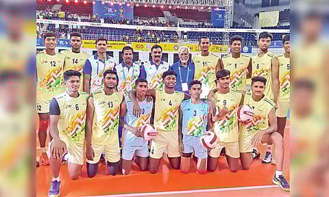 The victorious TN boys volleyball team pose after the final match