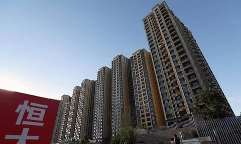 An Evergrande sign is seen near residential buildings at an Evergrande residential complex in Beijing