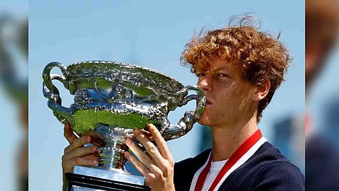 Italy's Jannik Sinner poses with the Australian Open trophy (Reuters)